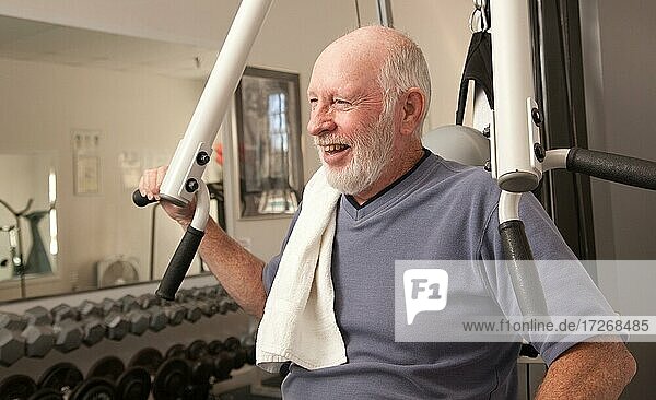 Senior adult man working out in the gym