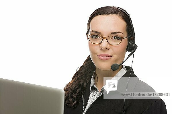 Helpful mixed-race receptionist in front of computer wearing phone head-set isolated on white background