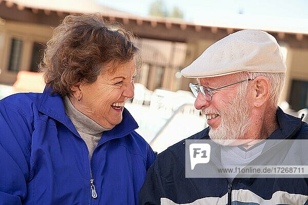 Happy senior adult couple portrait bundled up outdoors