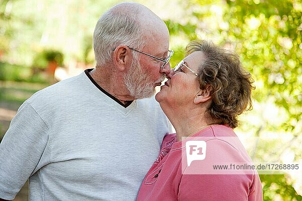 Loving senior couple kissing and enjoying the outdoors together