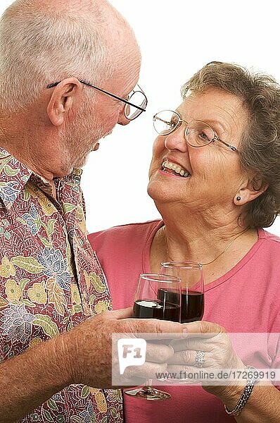 Happy senior couple toasting with wine glasses