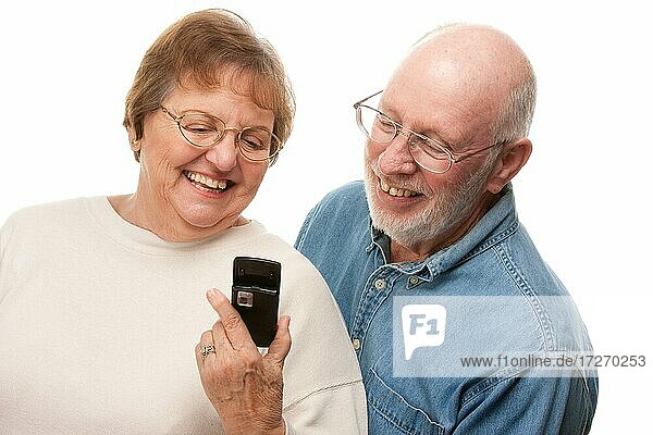 Happy senior couple using cell phone isolated on a white background