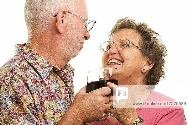 Happy senior couple toasting with wine glasses
