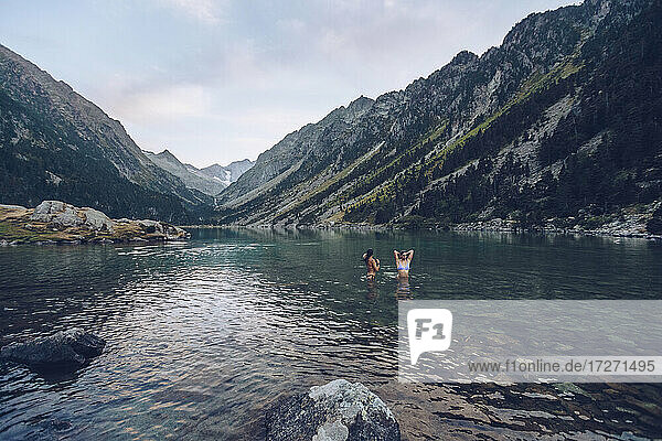 Young women taking bath in lake of Gaube