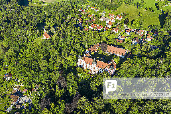 Germany  Bavaria  Eurasburg  Drone view of Eurasburg Castle surrounded by green grove