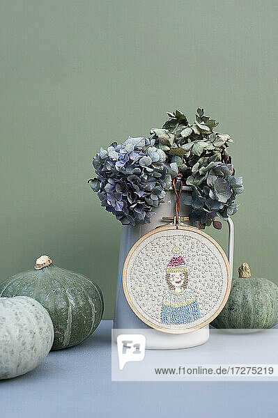 Kürbisse  Krug mit getrockneten Hortensien und Wintermotiv-Stickerei