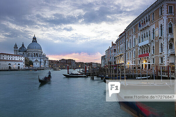 Italy  Veneto  Venice  Gondolas moored in marina in front of Santa Maria della Salute at dusk