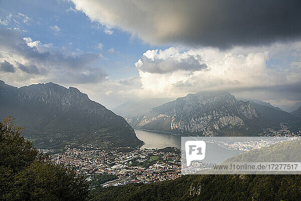 Scenic view of cityscape with Lake Como and mountains against sky at sunset