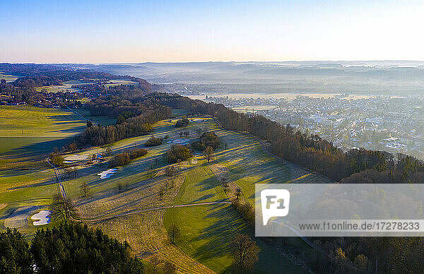 Germany  Bavaria  Wolfratshausen  Drone view of rural golf course at foggy autumn dawn