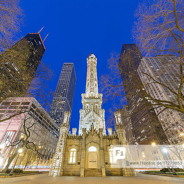 Illuminated Chicago Water Tower in city at dusk  Chicago  USA