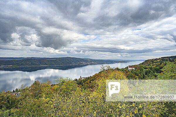 Clouds over Lake Constance ale lakeshore forest in autumn