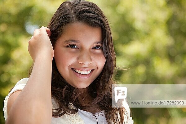 Cute happy hispanic girl in the park