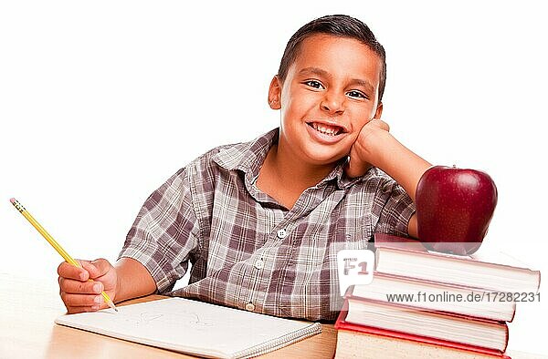 Adorable hispanic boy with books  apple  pencil and paper isolated on a white background