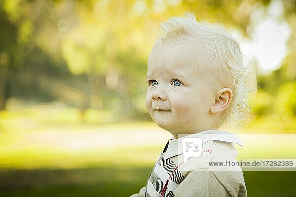 Adorable little blonde baby boy outdoors at the park