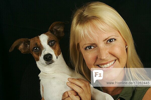 Attractive woman holds her jack russell terrier dog