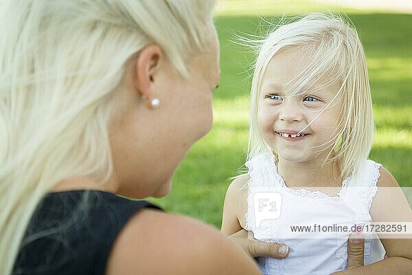 Cute little girl having fun with her mother outside