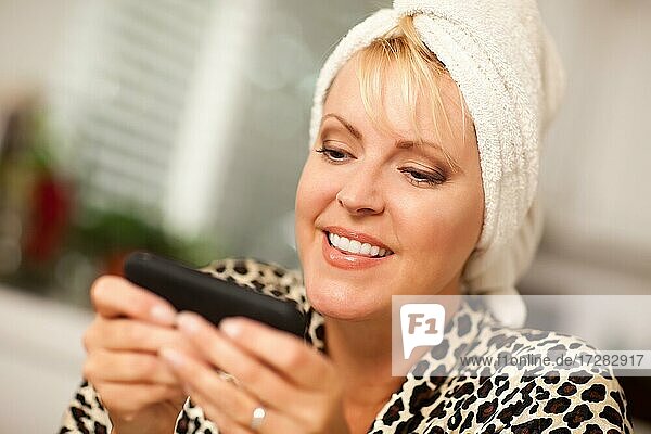 Attractive woman texting with her cell phone with narrow depth of field