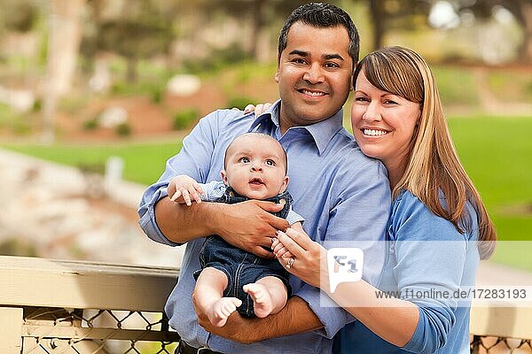 Happy mixed-race family posing for A portrait in the park