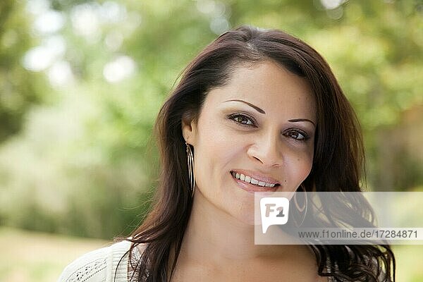 Attractive hispanic woman portrait in the park