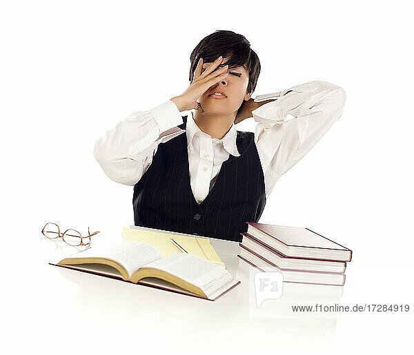 Frustrated mixed-race young adult female student at white table with books and paper isolated on a white background