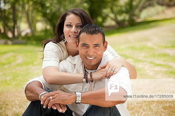 Affectionate happy hispanic couple in the park