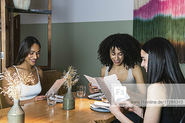 Female friends checking menu in restaurant