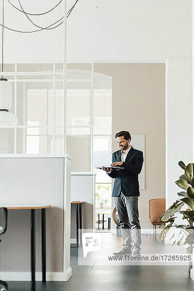Businessman using digital tablet while working at office