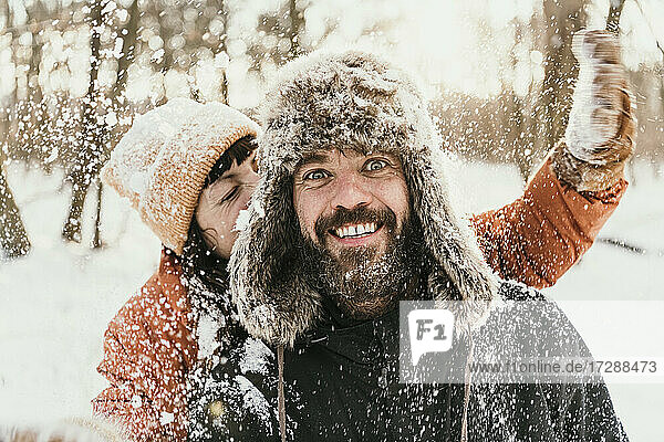 Couple having fun in forest during winter