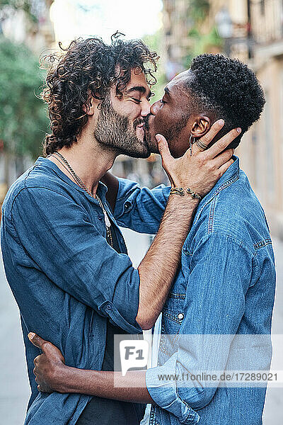 Gay couple with eyes closed kissing each other