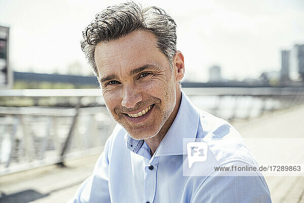 Smiling mature businessman during sunny day
