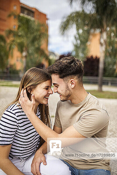 Smiling girlfriend with boyfriend in park