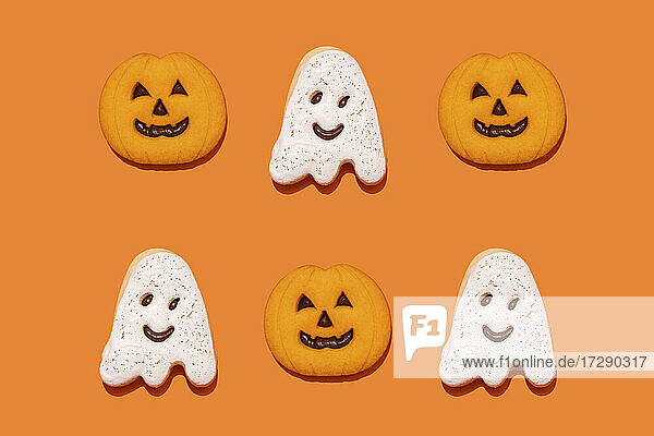 Studio shot of ghost and jack o lantern-shaped Halloween cookies