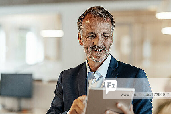 Male entrepreneur using digital tablet in office