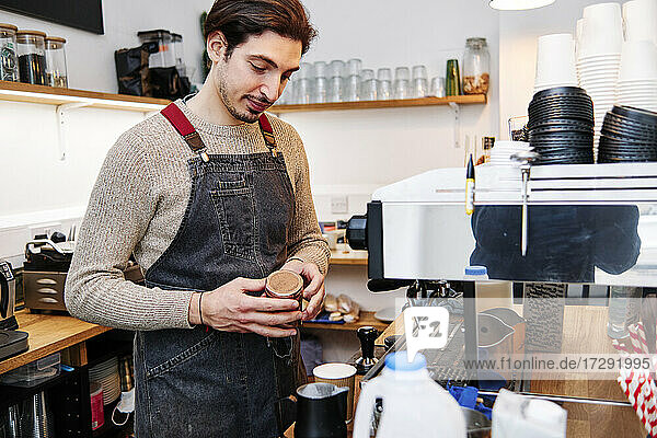 Male owner preparing coffee at shop