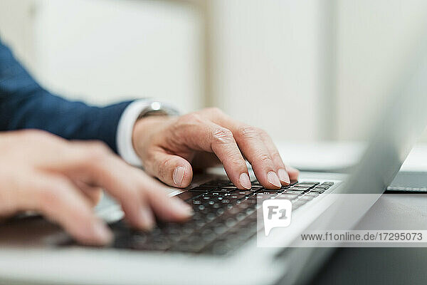 Male entrepreneur using laptop at office