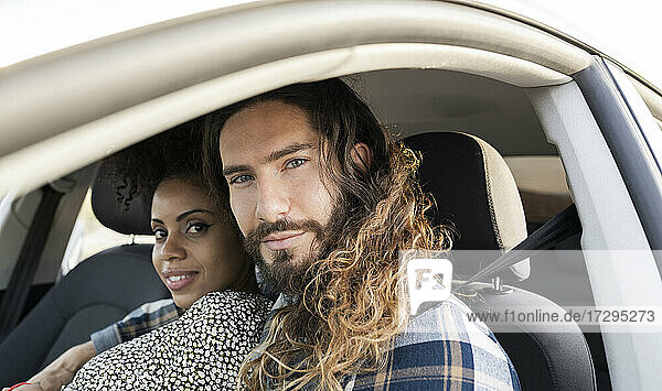 Mid adult couple staring while sitting in car