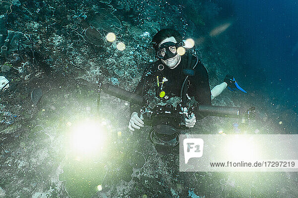 underwater photographer looking at camera in Raja Ampat