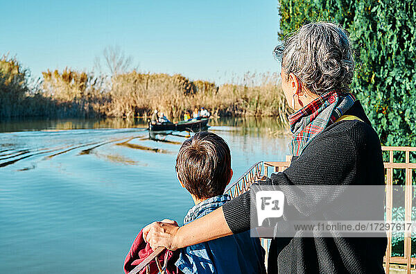 Mother with her son looking at the boats