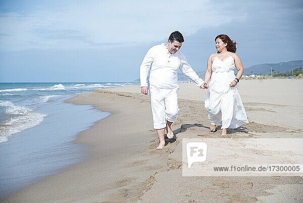Couple in love  Hispanic man with Latin woman  walking on the beach.