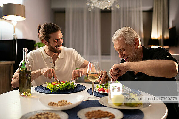 Grandfather and grandson having dinner together