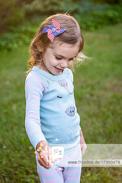 Girl Holding Sparkler with 4th of July Pin