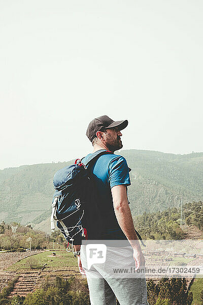 Man with cap and backpack in the mountain
