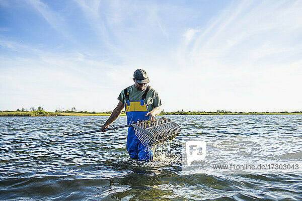 Man working on the water in aquaculture oyster farm