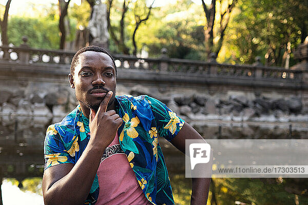 A young black man in park. Outdoor portrait of traveler. Portrait
