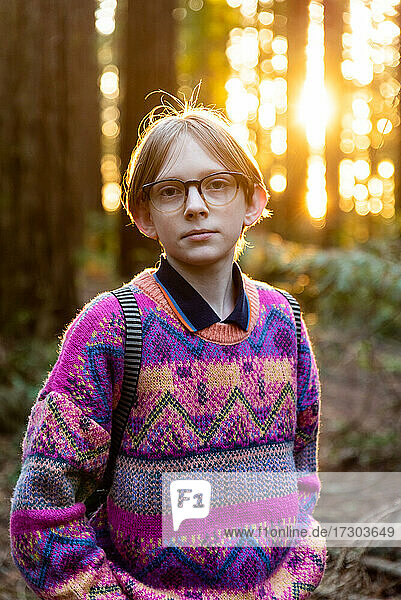 Portrait of calm young person looking at camera in redwood grove