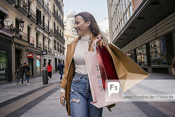 Beautiful woman holding shopping bags and smiling