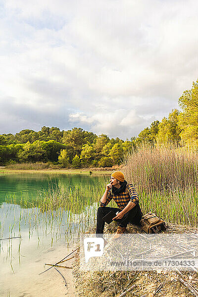 traveler contemplating beautiful scenery sitting looking at the lake
