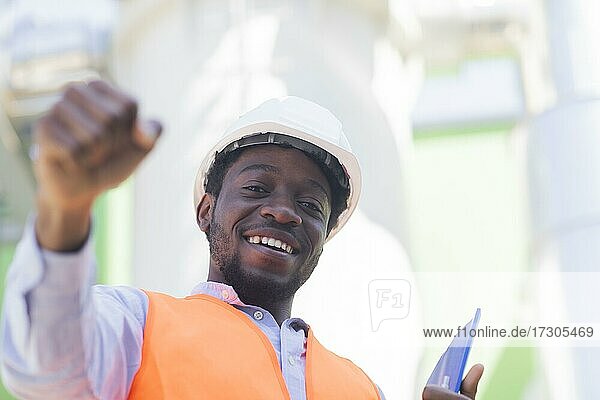 Young black man working outside as technician with helmet and safety vest  Freiburg  Baden-Württemberg  Germany  Europe