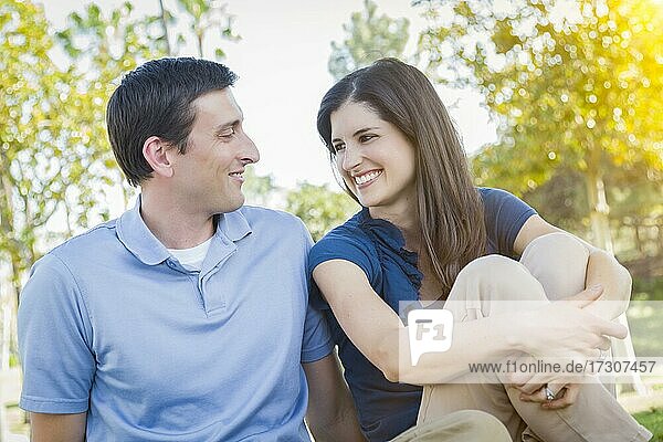 Young attractive couple portrait outdoors in the park