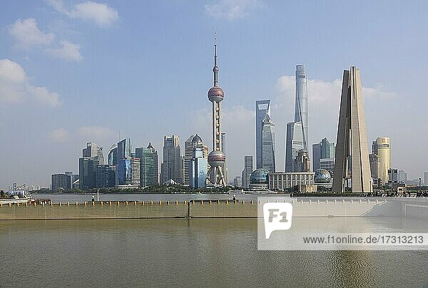Skyline of the special economic zone Pudong with Oriental Pearl Tower  Shanghai World Financial Center and the 632 meter high Shanghai Tower  right in front Shanghai People's Heros Memorial Tower  Shanghai  People's Republic of China